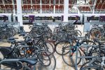 A bicycle locked at a railway station bike rack