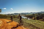 A mountain biker tackling a technical rocky trail in the English countryside