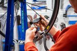 A bicycle mechanic working on a bike in a workshop