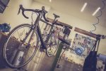 Bicycles secured on display racks inside an independent bike shop