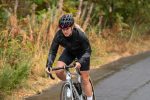 Cyclist riding in wet weather wearing a waterproof jacket from Madison's AW26 range