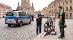 Police officer using a mobile testing device on an electric bike at the roadside
